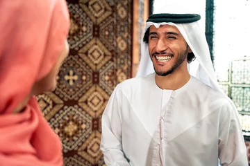 Fotobehang Young couple from Emirati spending time in a cafe © oneinchpunch