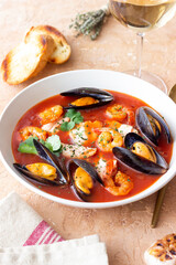 Bouillabaisse soup with fish, mussels and shrimps. French cuisine. Seafood.
