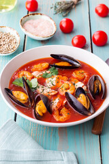 Bouillabaisse soup with fish, mussels and shrimps. French cuisine. Seafood.