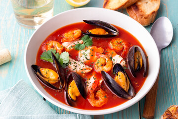 Bouillabaisse soup with fish, mussels and shrimps. French cuisine. Seafood.