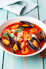 Bouillabaisse soup with fish, mussels and shrimps. French cuisine. Seafood.