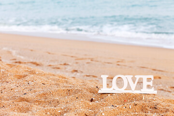 wooden letters on the beach