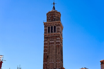 Fototapeta na wymiar Old town of Italian City of Venice with church tower of Basilica di Santa Maria Gloriosa dei Frari on a sunny summer day. Photo taken August 7th, 2023, Venice, Italy.