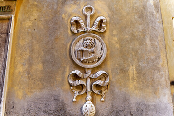 Close-up of weathered facade with winged lion at facade of historic house at Italian City of Venice...