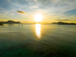 Amazing sunset or sunrise sky over sea landscape,Beautiful colorful light of nature with boats in the sea,Drone camera shot,Top down nature view seascape