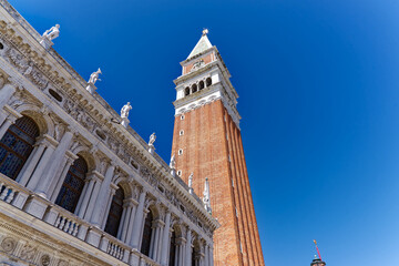 Fototapeta na wymiar Old town of Italian City of Venice with famous Campanile of cathedral at Piazza San Marco square on a sunny summer day. Photo taken August 7th, 2023, Venice, Italy.