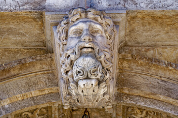 Close-up of sculpture of men's head on top of famous Rialto Bridge at City of Venice on a cloudy summer day. Photo taken August 6th, 2023, Venice, Italy.