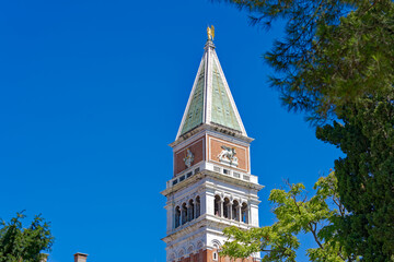 Piazza San Marco with top of Campanile di San Marco with golden angel on top at City of Venice on a sunny summer day. Photo taken August 7th, 2023, Venice, Italy.