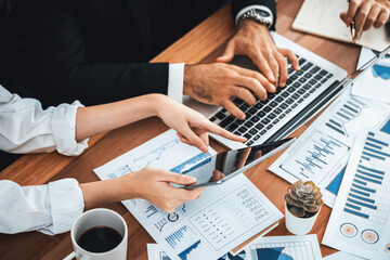Naklejka premium Diverse group of business analyst team analyzing financial data report paper on office table. Chart and graph dashboard by business intelligence analysis for strategic marketing planning Meticulous