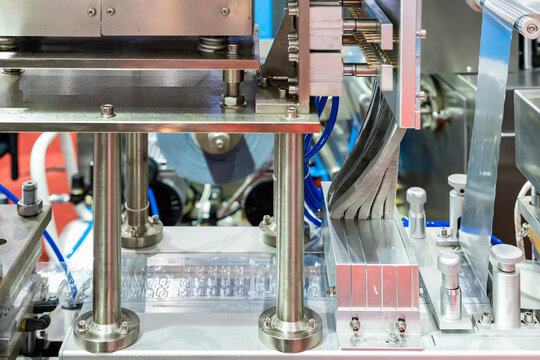 Close up plastic film after forming and material loading unit or tablets feeding system and other component of automatic continuous blister packing machine in pharmaceutical industrial