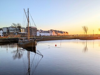 Beautiful sunrise scenery with old wooden boats Galway hookers at Claddagh in Galway city