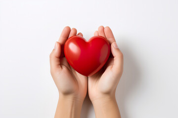 Fototapeta premium hands hold a red heart on a white background