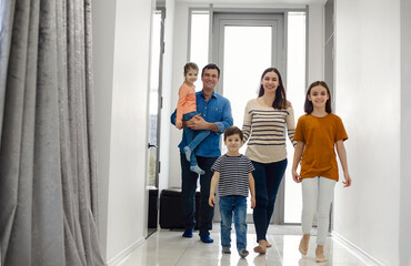 Fototapeta premium Children returning home with parents mom and dad, smiling cute children brother and sisters,