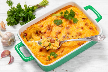 cheesy smoked sausage grits bake in ceramic dish