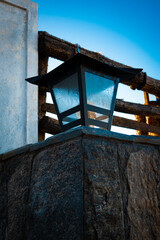 An elegant wall-mounted outdoor lamp gracefully illuminates the surroundings beneath the vibrant...