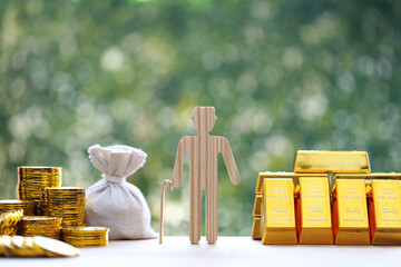 Mutual fund,Seniorman with gold bar and stack of gold coin money on natural green background, Save...