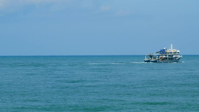 Fisherman Boat In The Black Sea. Lonely Fishing Boat Sails On The Sea With Nets On Board. Still.