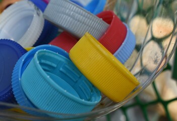Plastic bottle seal cap in a recycle basket