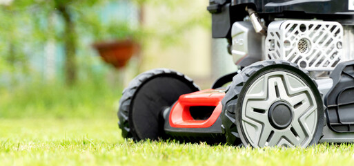 lawn mower on a green lawn on a sunny day