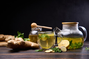 natural organic herbal tea in glass teapot on a wooden table