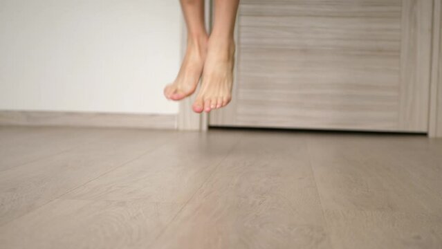 child jumping on a skipping in room rope close-up legs video silhouette. happy family kid dream concept. baby feet jumping on a skipping rope.