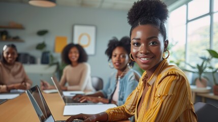 Obraz premium Smile African American female creative businesswoman start-up looking camera working with colleagues sitting in cozy workplace meeting room, modern home office with technology laptop computer on table