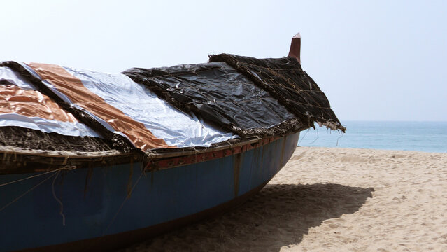 Fishing boat moored on the beach at Adimalathura, Thiruvananthapuram, Kerala, India