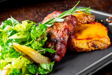 grilled meat with baked potatoes and salad