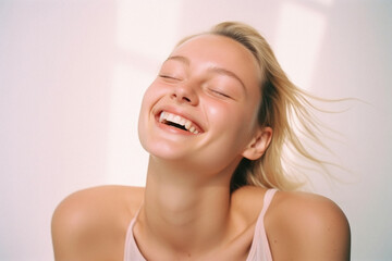 Naklejka premium Portrait of a happy young woman smiling on a white background .