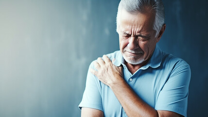 Senior elderly man touching his shoulder, shoulder health problems. Healthcare, insurance - obrazy, fototapety, plakaty