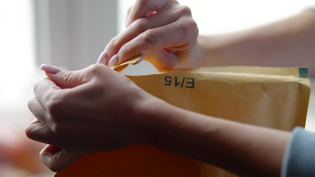 Person opening package that they received in mail from an online store