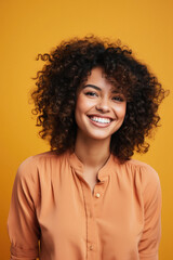 Obraz na płótnie Canvas Portrait of a beautiful young african american woman smiling and looking at camera isolated over yellow background