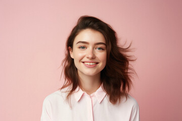 Fototapeta premium Portrait of beautiful young woman with flying hair on pink background .