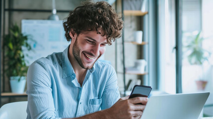 Happy man using a smartphone during his work in the office - obrazy, fototapety, plakaty