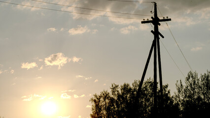 A power line pole at sunset