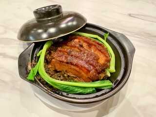 hot stone bowl of pork buns biapong bak pao  fillings of traditional chinese indonesian fusion cuisine of babi hong china hong kong braised pork belly cooked with sweet black ketchup sauce in surabaya