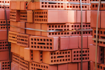 Delivery of red bricks a popular building material ready for the construction of a new home by...