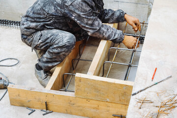 Installation of wood for concrete iron formwork, construction worker make stairs. construction of...