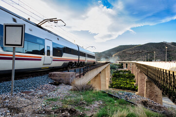 Passenger train moving on a bridge in motion