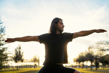 Body Health And Balance. Male Doing Yoga Outdoors.