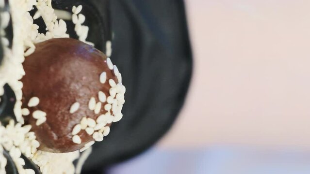 Chocolate candy adorned with sesame seeds. Chef employs top-quality ingredients leaving no stone unturned to achieve exceptional taste