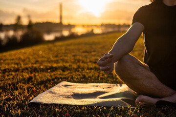 Hand Of Man Meditating In A Yoga Pose At Sunset.Yoga And Meditation Pose
