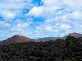 Spectacular view of the Fire Mountains at Timanfaya National Park, this unique area consisting entirely of volcanic soils. Volcanic landscape in a sea of ​​lava. Plenty space of text. Lanzarote, Spain