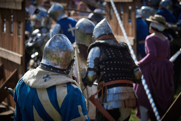 Battle of medieval knights. Medieval warriors in armor. Reenactors of historical events.