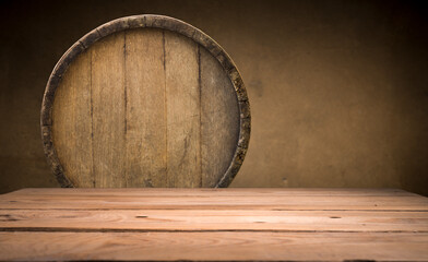 Wooden table in front of blurred oak barrel background, background of whisky and wine. High quality photo