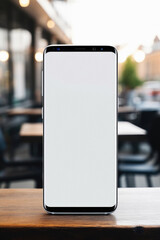 Mockup image of smartphone with blank white screen on wooden table in cafe