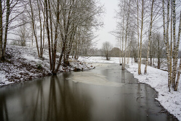 near frozen river in late autumn - 708443117
