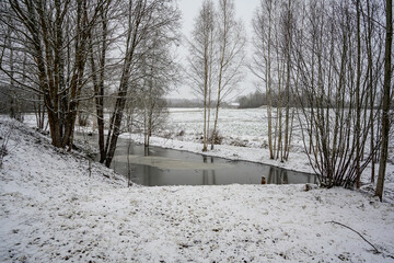 near frozen river in late autumn - 708443140
