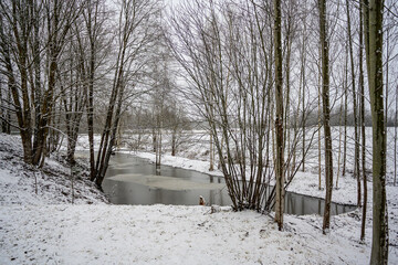 near frozen river in late autumn - 708443141