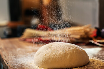 sprinkle flour on the dough while preparing the bread sourdough for the first rise. wheat flour...